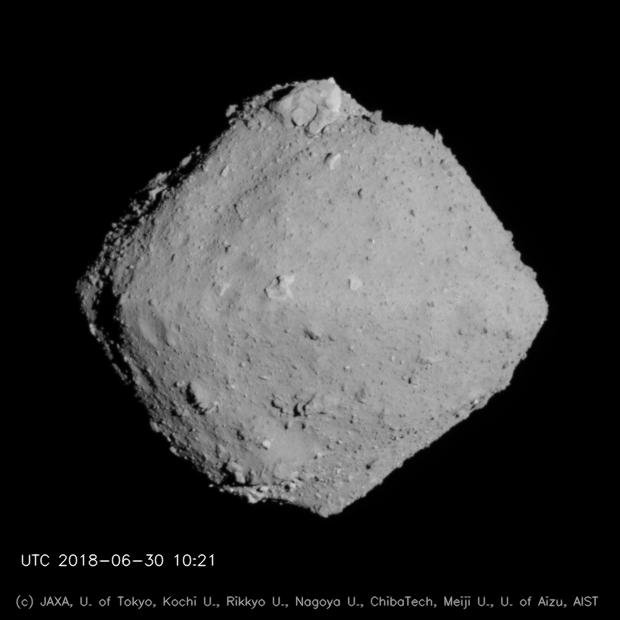 In this Hayabusa 2 image of the asteroid Ryugu, the boulder Otohime Saxum is clearly visible at the top. That little boulder is the same size as Didymoon. In fact, Didymoon at one time may have been a rock on the surface of Didymos, before it detached and started orbiting Didymos. Image Credit: JAXA, University of Tokyo, Kochi University, Rikkyo University, Nagoya University, Chiba Institute of Technology, Meiji University, University of Aizu and AIST