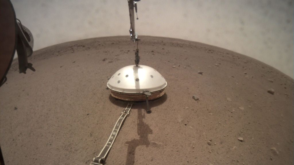 The InSight lander has deployed SEIS's wind and thermal shield. Image Credit: NASA/JPL-CalTech