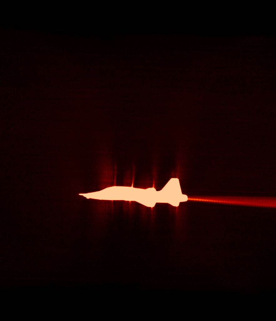 An older image from the previous imaging system shows a single T-38 in what is called "transonic flight," the exact moment the aircraft transitions from sub-sonic to supersonic flight. Image Credit: NASA