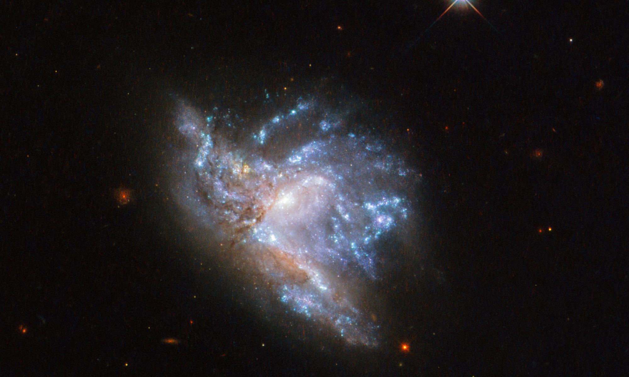 Located in the constellation of Hercules, about 230 million light-years away, NGC 6052 is a pair of colliding galaxies. Image Credit: ESA/Hubble & NASA, A. Adamo et al.