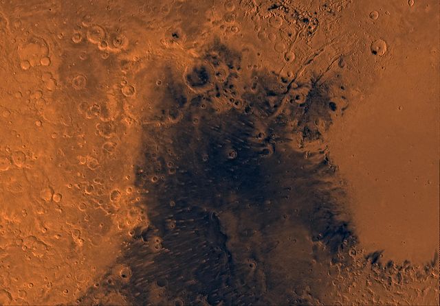 The Syrtis Major region on Mars is one of the three areas on Mars with the largest dune movement. Image Credit: By NASA - http://photojournal.jpl.nasa.gov/catalog/PIA00173, via en:Image:Syrtis Major MC-13.jpg, Public Domain, https://commons.wikimedia.org/w/index.php?curid=978884