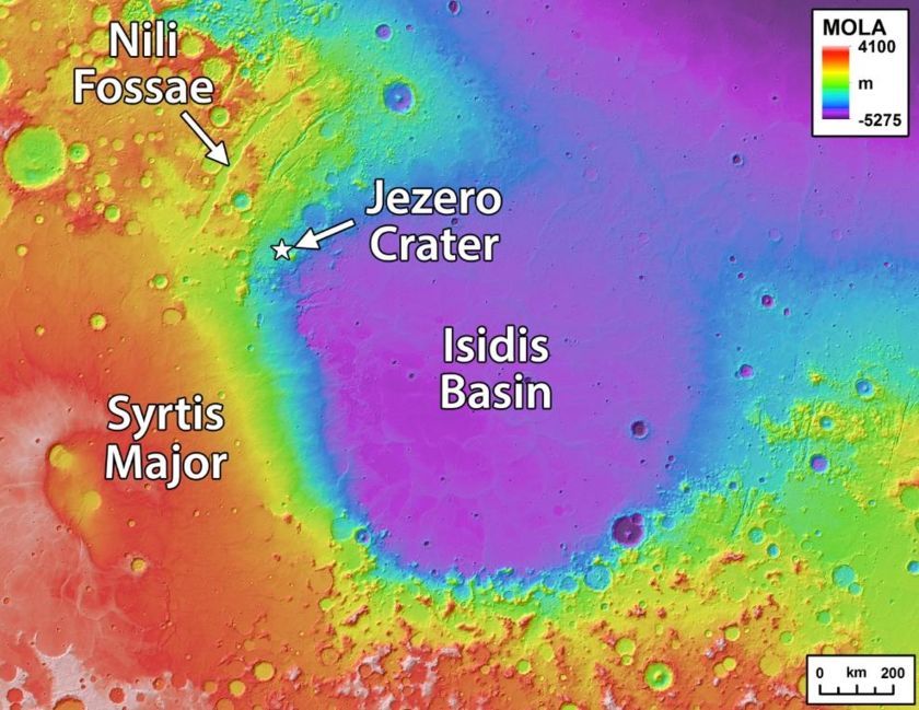 Jezero Crater is located on the edge of the Isidis Basin (or Isidis Planitia), a massive impact basin. In this MOLA (Mars Orbital Laser Altimeter) image, purple is low elevation and red is high elevation. Image Credit:  By NASA / JPL / USGS - [1], Public Domain, https://commons.wikimedia.org/w/index.php?curid=74634265