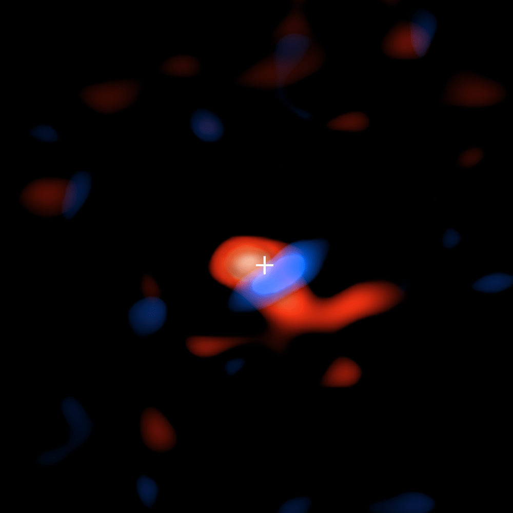 The ALMA image of the disk of cool hydrogen gas flowing around the supermassive black hole at the center of our galaxy. The colors represent the motion of the gas relative to Earth: the red portion is moving away, so the radio waves detected by ALMA are slightly stretched, or shifted, to the "redder" portion of the spectrum; the blue color represents gas moving toward Earth, so the radio waves are slightly scrunched, or shifted, to the "bluer" portion of the spectrum. The crosshairs indicate location of black hole. Image Credit: ALMA (ESO/NAOJ/NRAO), E.M. Murchikova; NRAO/AUI/NSF, S. Dagnello