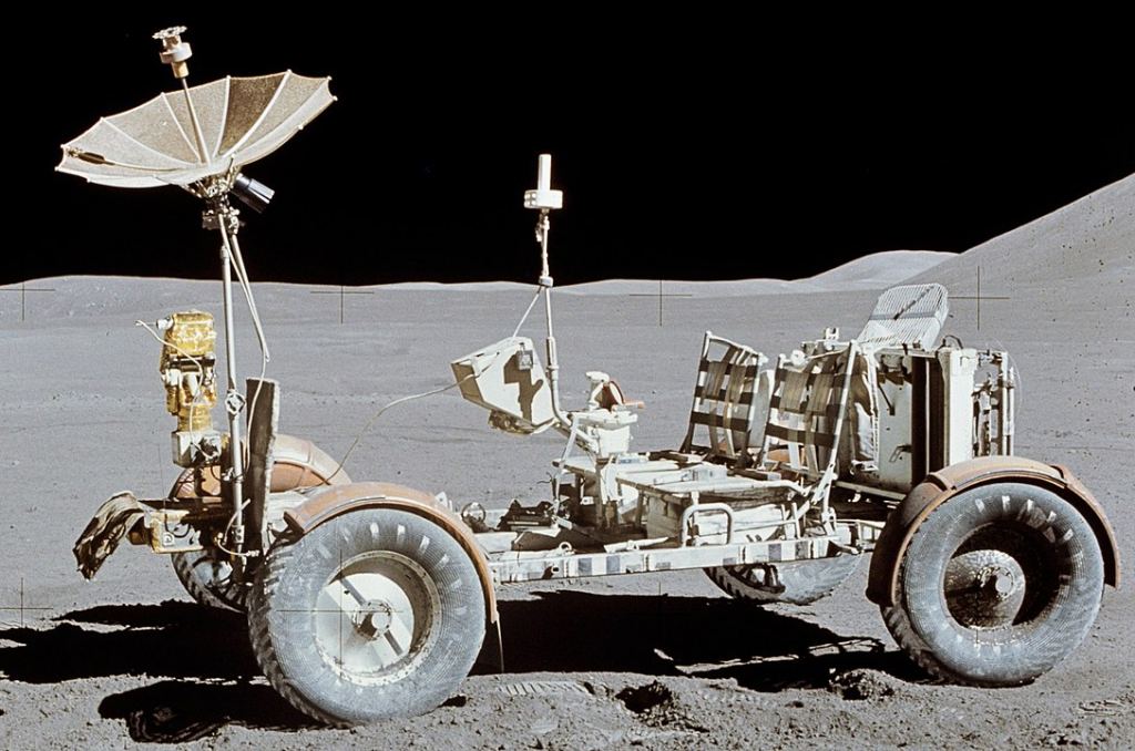 NASA's Lunar Roving Vehicle at its final resting place on the Moon. It looks primitive compared to the proposed Toyota/JAXA vehicle. Image Credit: By NASA/Dave Scott; cropped by User:Bubba73 - http://www.hq.nasa.gov/office/pao/History/alsj/a15/images15.html (direct link), Public Domain, https://commons.wikimedia.org/w/index.php?curid=6057491