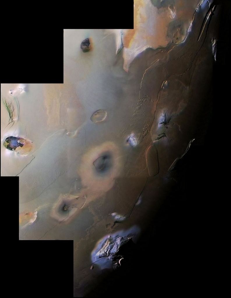 Io's surface is marked with volcanic features and mountains. This Voyager 1 mosaic covers Io's south polar region. At the bottom of the image is Haemus Mons, 1 10 km. high mountain. The rest of the image is typical of Io, with flat volcanic plains, eroded volcanic plateaus, and cratered volcanic calderas. Image Credit: By NASA / Jet Propulsion Laboratory / USGS - http://photojournal.jpl.nasa.gov/catalog/PIA00327, Public Domain, https://commons.wikimedia.org/w/index.php?curid=18530344