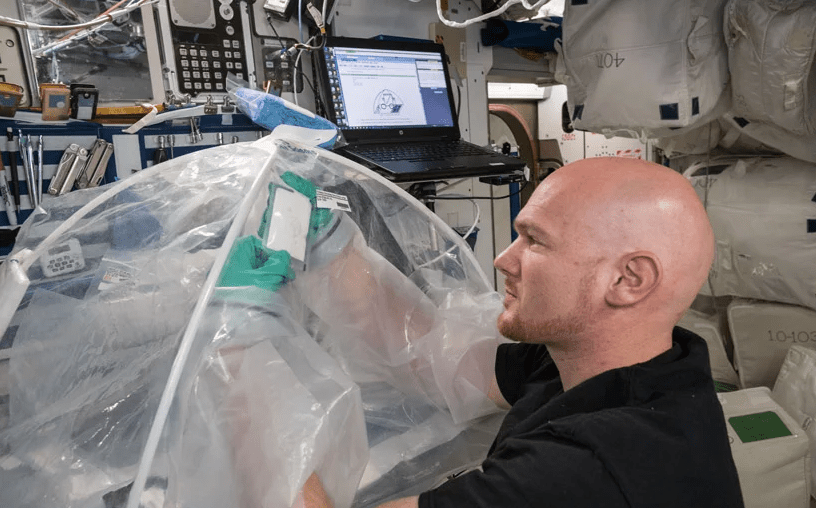 ESA astronaut Alexander Gerst adding water to packets of cement on the ISS. Image Credit: NASA