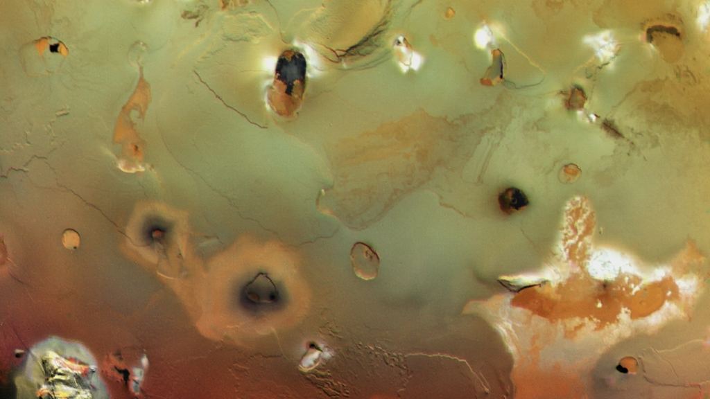 The surface of Io is covered with dark, collapsed volcanoes. Image Credit:  NASA/JPL/USGS 