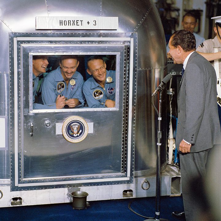 The Apollo 11 astronauts in the Mobile Quarantine Facility on the aircraft carrier USS Hornet, with President Richard Nixon visiting them. By NASA - NASA on The Commons (image link), Public Domain, https://commons.wikimedia.org/w/index.php?curid=20918764