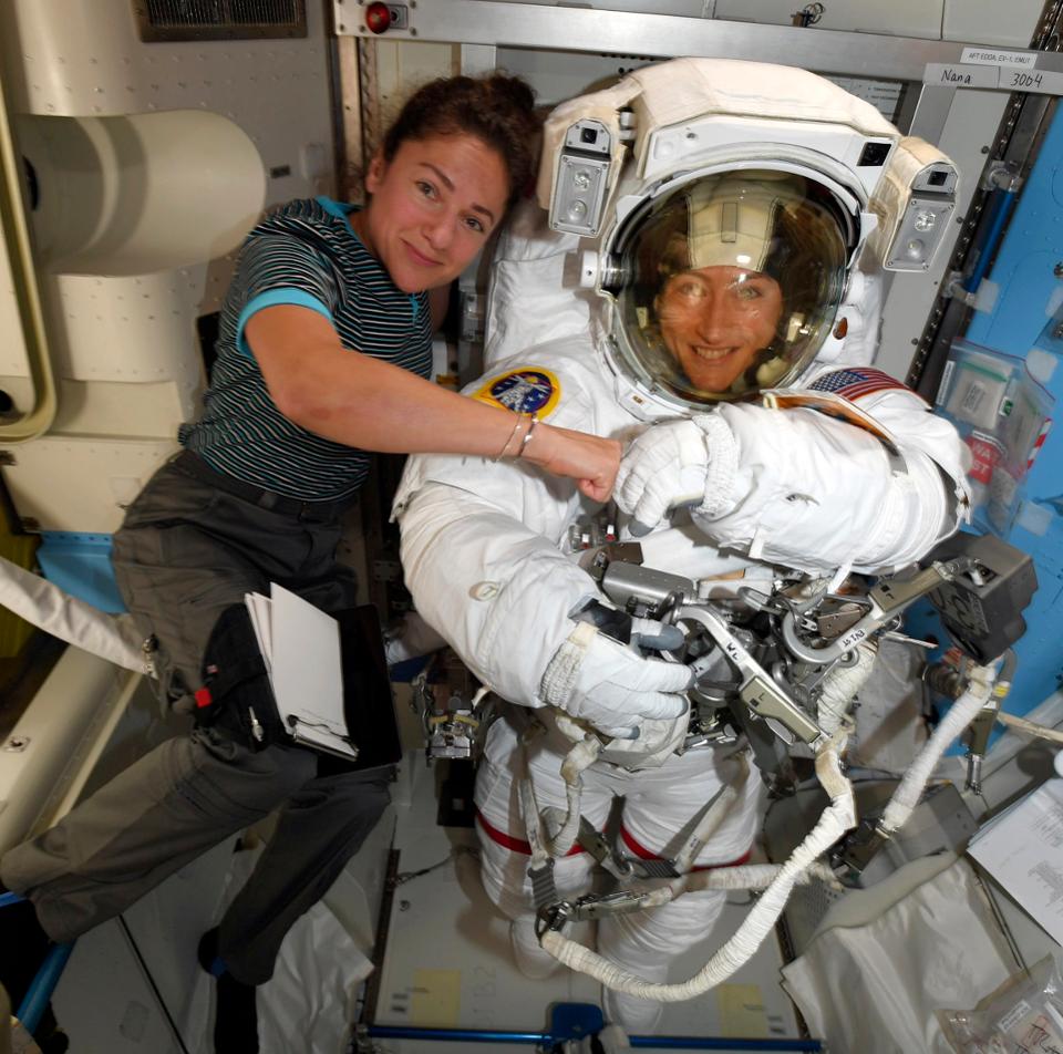 NASA astronauts Christina Koch, right, and, Jessica Meir pose on the International Space Station. The new xEMUS will be designed from the ground up to fit both women and men. Image Credit: NASA