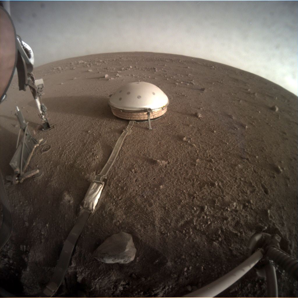 The InSight lander is gathering data on Mars' interior. Though Mars is far from being a Super-Earth, the data InSight is gathering will help scientists understand planetary interiors better in general. The SEIS (Seismic Experiment for Interior Structure) instrument is under the white protective in this image. Image Credit: NASA/JPL