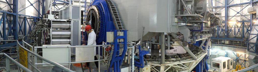 This view shows the VLT Unit Telescope 4 inside its enclosure. The telescope itself appears in the centre and the new MUSE instrument is on the left. This unique and powerful tool for discovery uses 24 spectrographs to separate light into its component colours to create both images and spectra of selected regions of the sky. MUSE couples the discovery potential of an imaging device with the measuring capabilities of a spectrograph, while taking advantage of the much better image sharpness provided by adaptive optics. Image Credit:  Eric Le Roux/University Claude Bernard Lyon 1/CNRS/ESO 