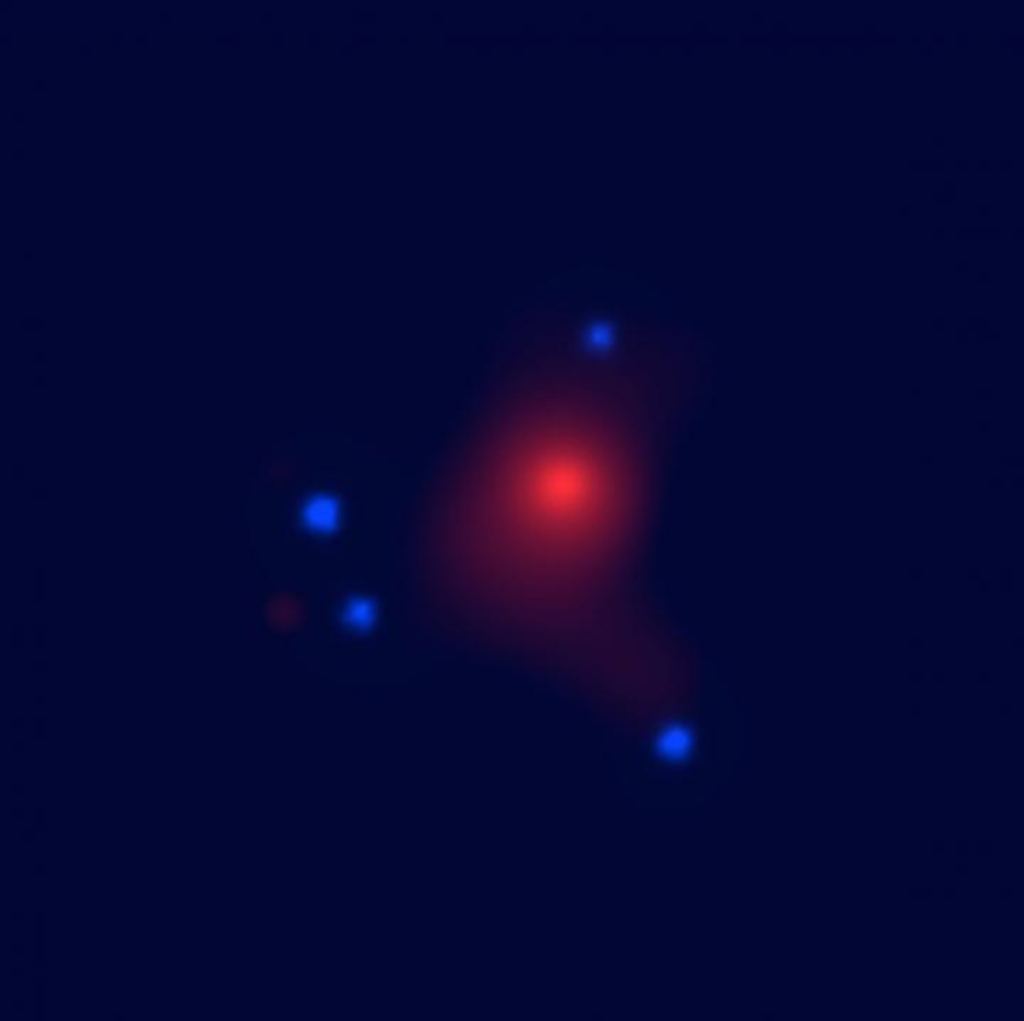 ay image of the gravitational lens system SDSS J1004+4112 taken by NASA’s Chandra X-ray Observatory; the central red extended emission is from the hot gas in the foreground lens galaxy cluster and the four blue point sources are the lensed images of the background quasar. Image credit: University of Oklahoma. 