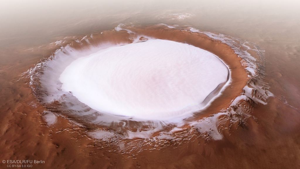 A gorgeous perspective image of the Korolev crater on Mars from the Mars Express' HRSC instrument. The Korolov crater is about 80 km (50 miles) in diameter. Image Credit: By ESA/DLR/FU Berlin - http://m.esa.int/spaceinimages/Images/2018/12/Perspective_view_of_Korolev_crater, CC BY-SA 3.0, https://commons.wikimedia.org/w/index.php?curid=75209756