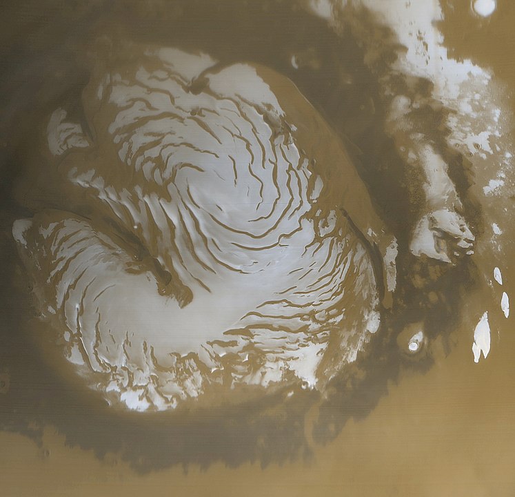 Another image of the northern polar cap on Mars, showing the intriguing spiral pattern of troughs in the ice. This image is from the Mars Global Surveyor. Image Credit: By NASA/JPL/Malin Space Science Systems - http://www.msss.com/mars_images/moc/may_2000/n_pole/ filehttp://photojournal.jpl.nasa.gov/catalog/PIA02800, Public Domain, https://commons.wikimedia.org/w/index.php?curid=4496369 