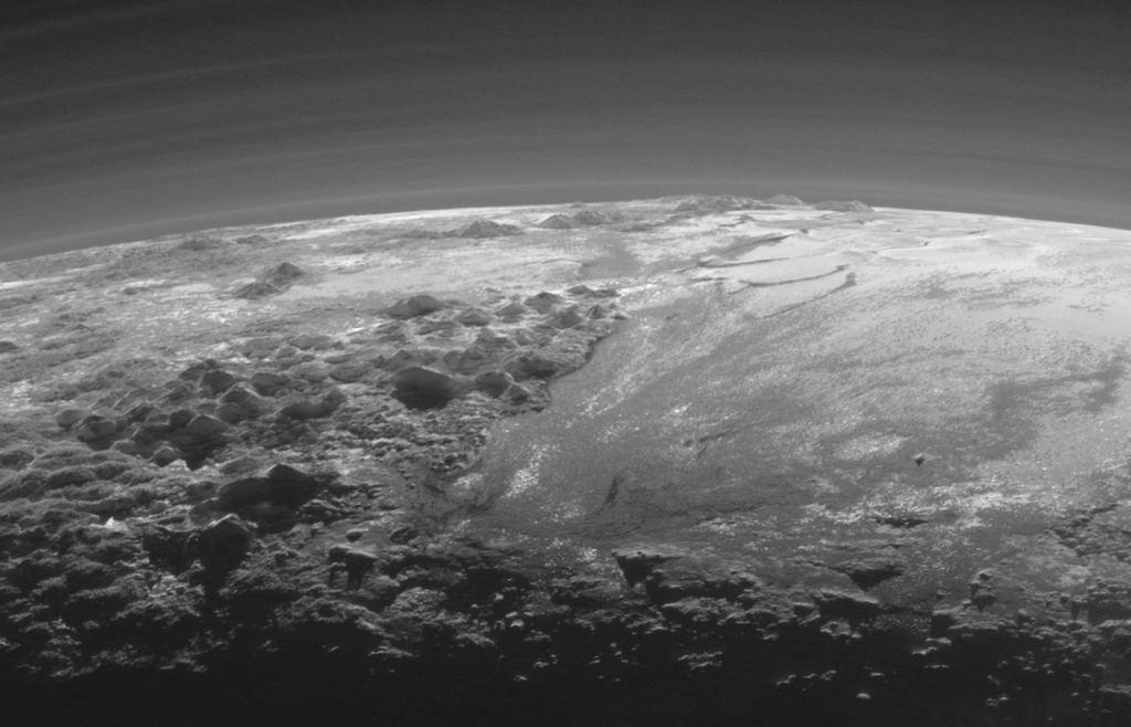  Just 15 minutes after its closest approach to Pluto on July 14, 2015, NASA's New Horizons spacecraft looked back toward the sun and captured a near-sunset view of the rugged, icy mountains and flat ice plains extending to Pluto's horizon. The smooth expanse of the informally named Sputnik Planum (right) is flanked to the west (left) by rugged mountains up to 11,000 feet (3,500 meters) high, including the informally named Norgay Montes in the foreground and Hillary Montes on the skyline. Image Credit: By NASA/Johns Hopkins University Applied Physics Laboratory/Southwest Research Institute. Public Domain