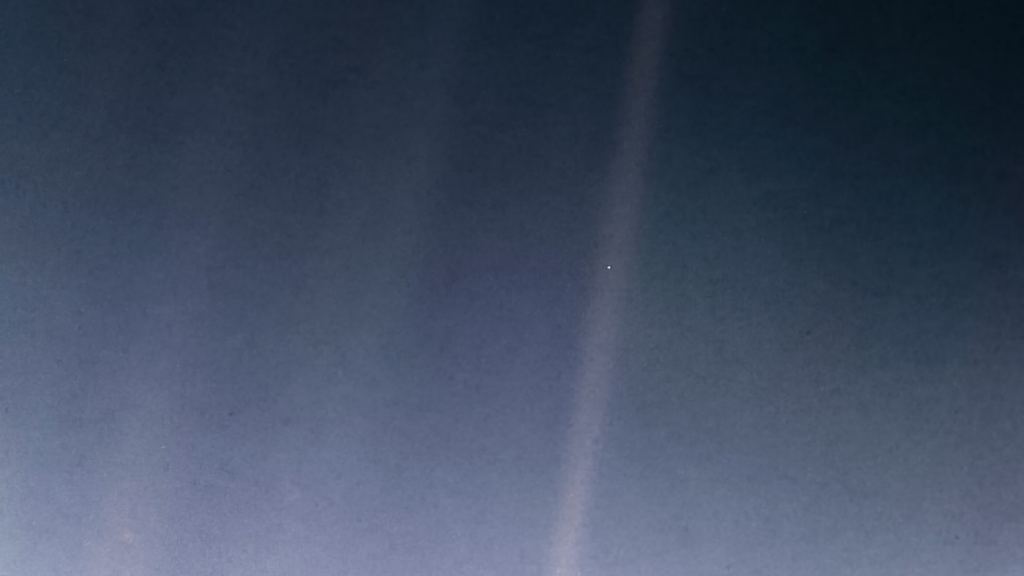 The famous "Pale Blue Dot" image Voyager took in the 70s of Earth as a star suspended in a sunbeam.
