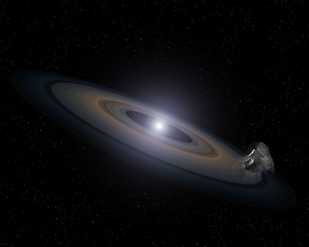 There are lots of white dwarfs, but could they support life? This is an artist’s impression of a white dwarf (burned-out) star accreting rocky debris left behind by the star’s surviving planetary system. It was observed by Hubble in the Hyades star cluster. At lower right, an asteroid can be seen falling toward a Saturn-like disk of dust that is encircling the dead star. Credit: NASA, ESA, and G. Bacon (STScI)