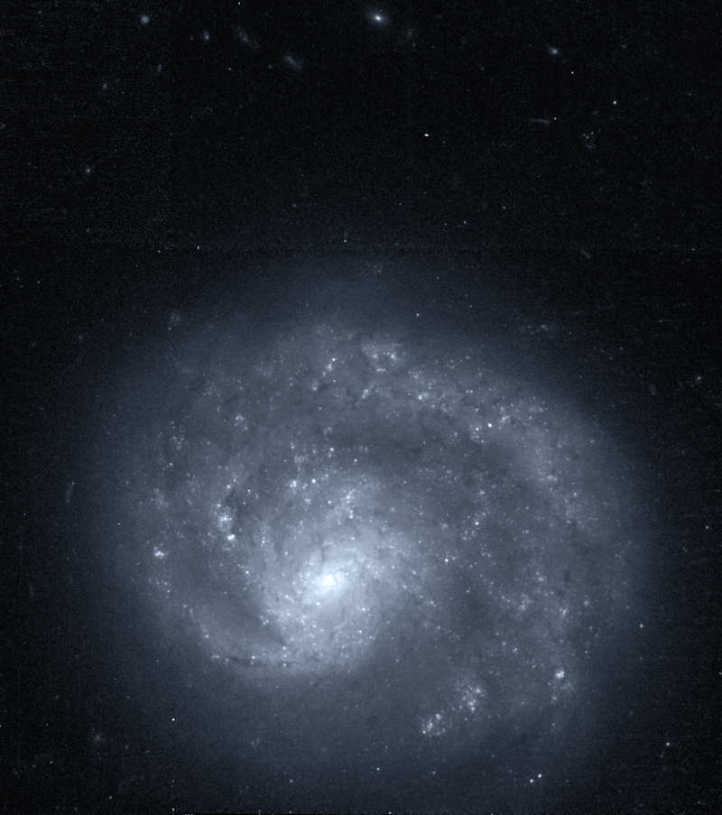 NGC 4625 is the one-armed galaxy's neighbour. Astronomers have considered whether gravitational interactions between the two galaxies could have given NGC 4618 its one-armed morphology. Image Credit: By Hubble Space Telescope - datafile from http://hla.stsci.edu/hlaview.html, Public Domain, https://commons.wikimedia.org/w/index.php?curid=37853717