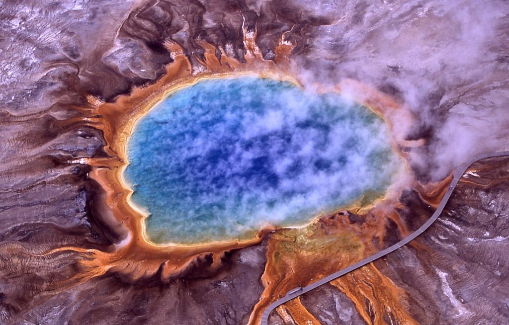The Grand Prismatic Spring in Yellowstone National Park. Microbial mats of extremophiles create the orange colors around the edge. Image Credit: By Jim Peaco, National Park Service - http://www.nps.gov/features/yell/slidefile/thermalfeatures/hotspringsterraces/midwaylower/Images/17708.jpgtransferred from the English Wikipedia, original upload 1 April 2004 by ChrisO, Public Domain, https://commons.wikimedia.org/w/index.php?curid=326389