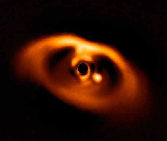 The image of PDS 70b from 2018. It's from the SPHERE instrument on the VLT. The planet is the bright point to the right of center. The star in the center is blacked out by the coronographs. Image Credit: By ESO/A. Müller et al., CC BY 4.0, https://commons.wikimedia.org/w/index.php?curid=70463981