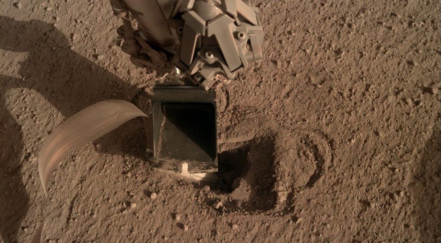 This image from May 2020 shows the scoop at the end of InSight's robotic arm to gently push on the Mole as it works its way into the ground. Image Credit: NASA/JPL/DLR