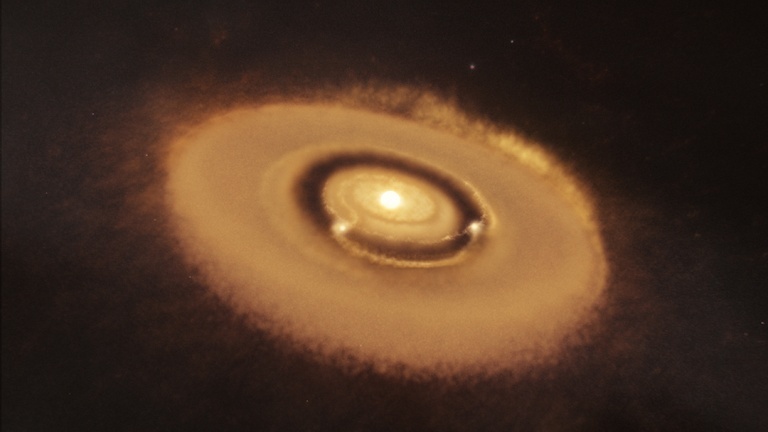 Artist’s impression of the PDS 70 system. The two planets are seen clearing a gap in the protoplanetary disk from which they were born. The planets are heated by infalling material that they are actively accreting, and are glowing red. Note that the planets and star are not to scale and would be much smaller in size compared to their relative separations. Image Credit: W. M. Keck Observatory/Adam Makarenko