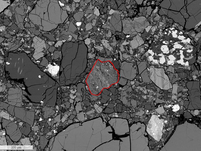 A microscopic image of the Kapoeta sample. One of the clasts, or inclusions, is highlighted in red. It clearly looks different from the rest of the sample. "They look completely different from surrounding material," lead author Liu said. Image Credit: Ogliore Lab
