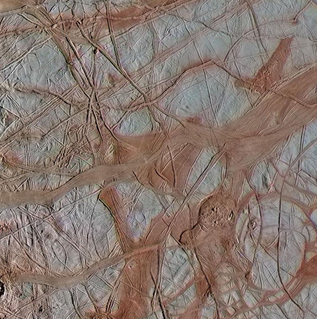 Another re-processed Galileo image. This one is of an area called Crisscrossing Bands, and it shows ridges which may form when a crack in the surface opens and closes repeatedly. In contrast, the smooth bands shown here form where a crack continues pulling apart horizontally, producing large, wide, relatively flat features. Image Credit: NASA/JPL-Caltech/SETI Institute