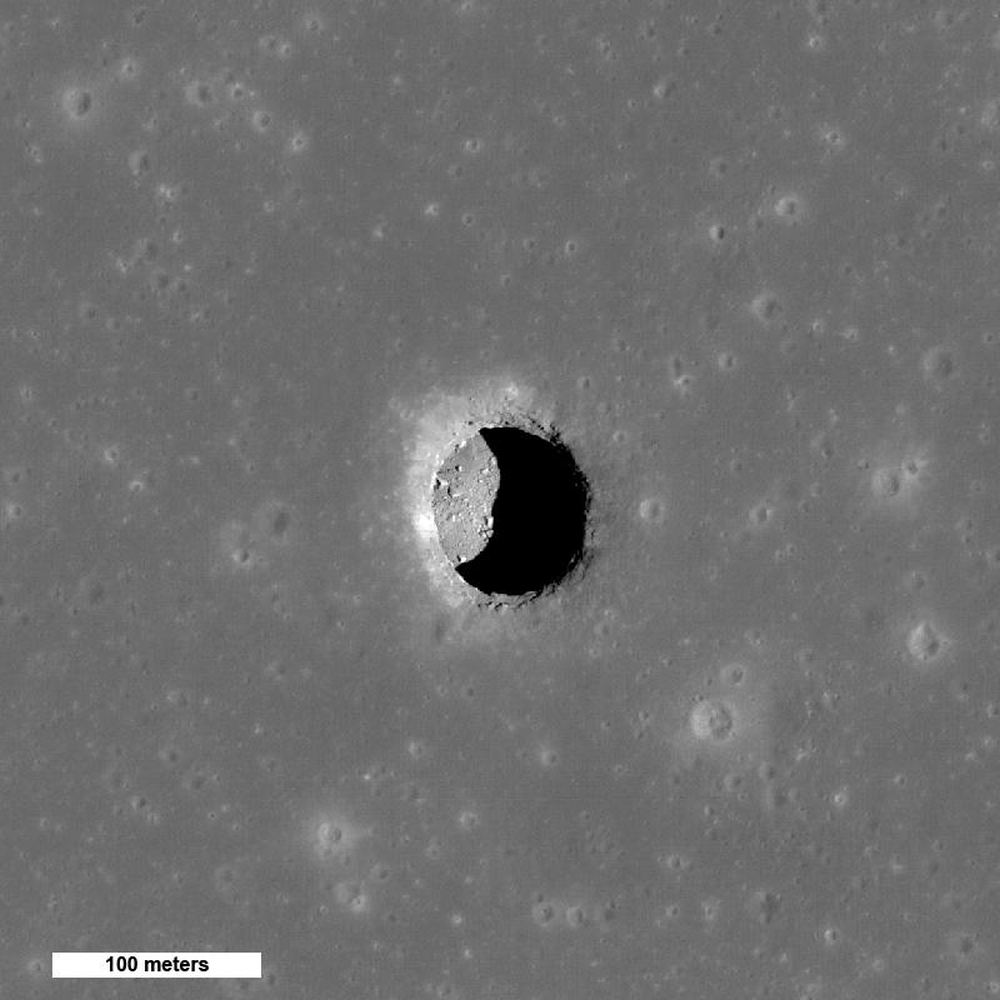 Spectacular high Sun view of the Mare Tranquillitatis pit crater revealing boulders on an otherwise smooth floor. The 100-meter pit may provide access to a lunar lava tube. Image Credit: By NASA/GSFC/Arizona State University - http://photojournal.jpl.nasa.gov/catalog/PIA13518, Public Domain, https://commons.wikimedia.org/w/index.php?curid=54853313