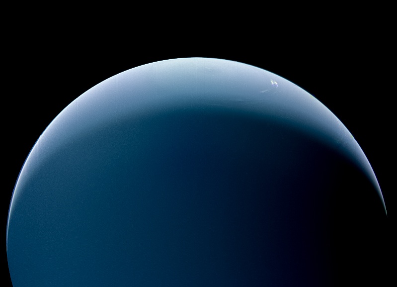 Neptune's south pole, with an artful swirl of white cloud. Image Credit: NASA/JPL-Caltech/Kevin M. Gill