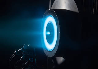 Image showing a type of electric propulsion being developed by NASA in action.