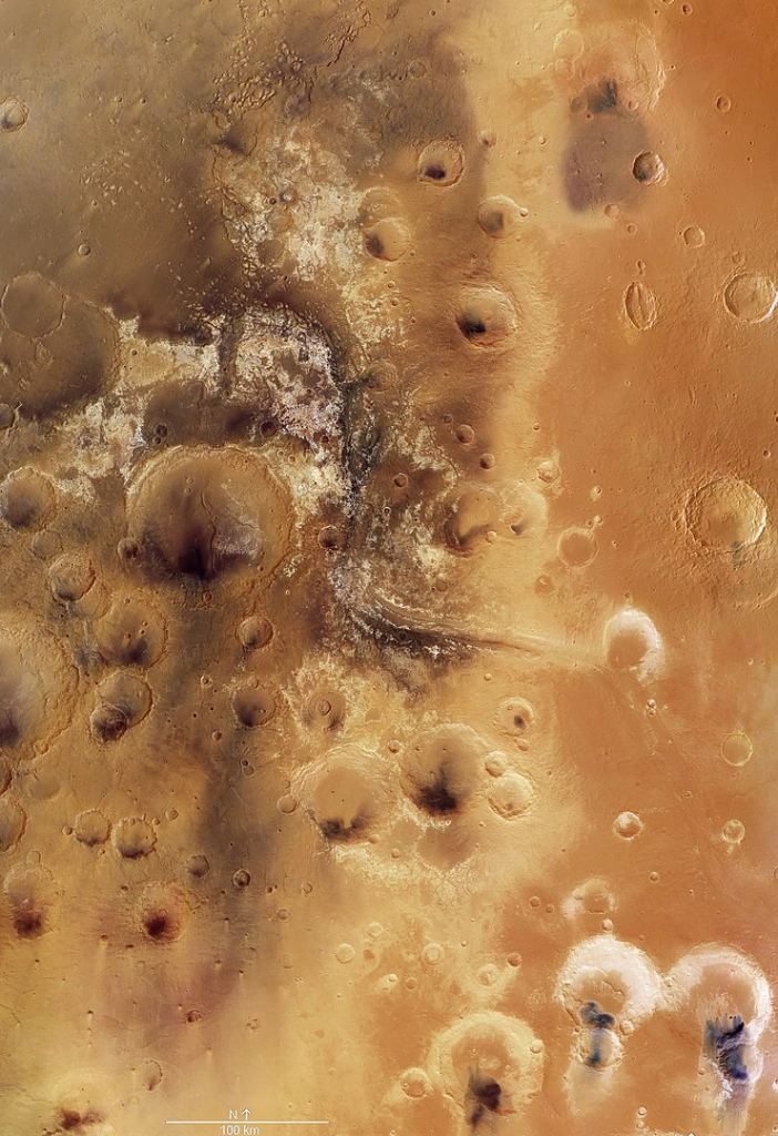 A satellite image of the Mawrth Vallis region, showing a 330,000 sq km (127,000 sq mi) region. The water flowed through Mawrth Vallis from the higher altitude area on the right to the lower plains on the left. The white regions along the valley are phyllosilicate minerals. This mosaic was created using nine individual images taken by the high-resolution stereo camera on ESA’s Mars Express spacecraft. Image Credit: By ESA/DLR/FU Berlin - http://www.esa.int/spaceinimages/Images/2016/09/Mawrth_Vallis_martian_mosaic, CC BY-SA 3.0, https://commons.wikimedia.org/w/index.php?curid=53917022