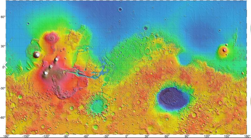 <Click to Enlarge> This topographic map of Mars from the Mars Orbiter Laser Altimeter (MMOLA) shows how Olympus Mons and the trio of volcanoes at Tharsis Montes dominate the Martian surface. Other volcanoes and lava flows dot the planet's surface. Image Credit: By NASA / JPL / USGS - https://attic.gsfc.nasa.gov/mola/images.html and http://photojournal.jpl.nasa.gov/catalog/PIA02993, Public Domain, https://commons.wikimedia.org/w/index.php?curid=32873138