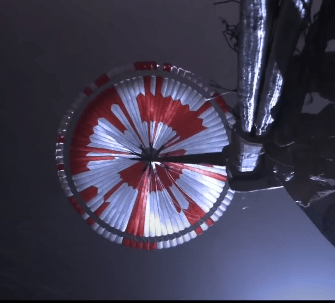 NASA is having some fun. The odd red pattern on the underside of Perseverance's parachute contain a 10-bit binary pattern that reads "Dare Mighty Things." Image Credit: NASA/JPL/Caltech