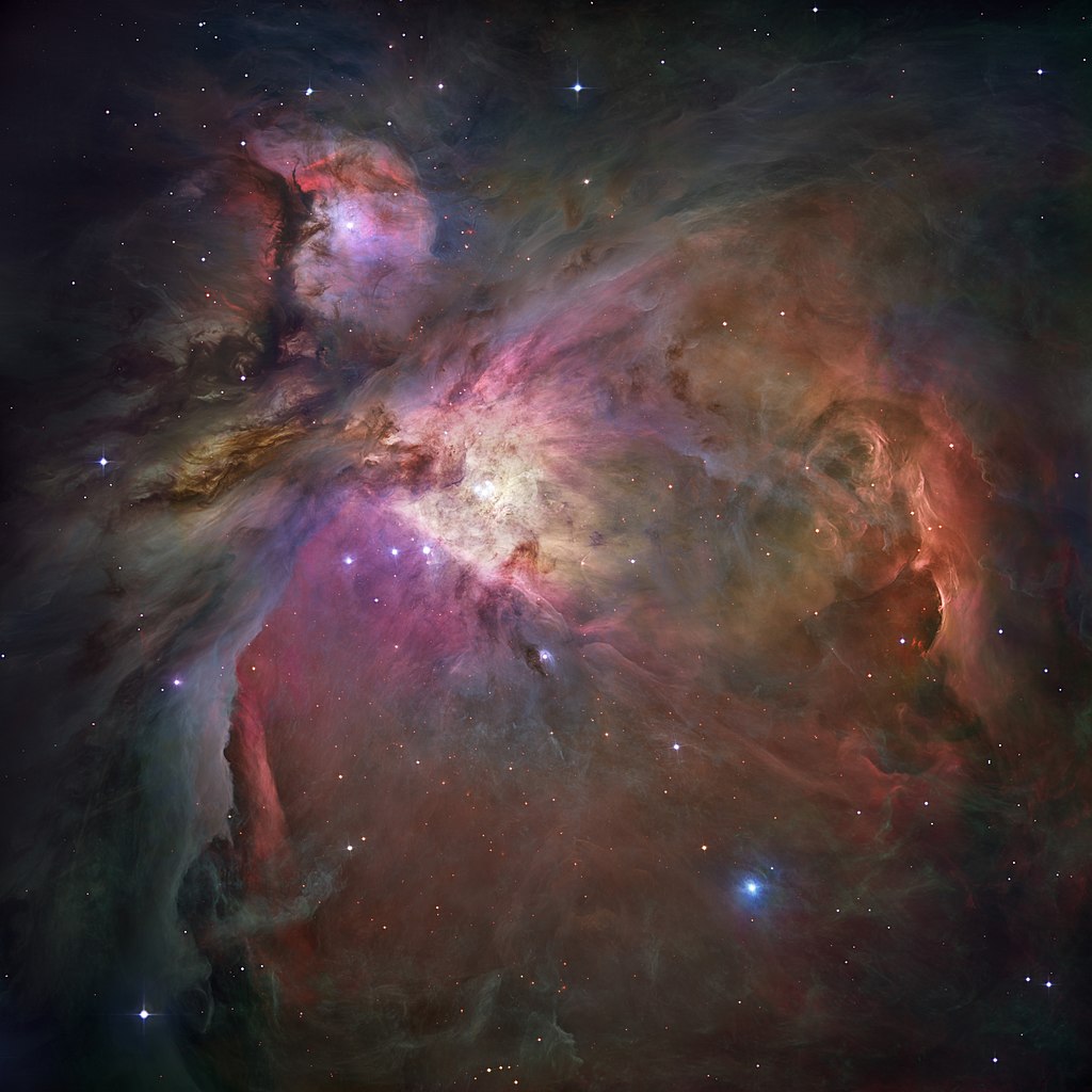 The Orion Nebula. The Trapezium Cluster is above and to the right of the three stars in Orion's Belt in this image. The stars in Trapezium are mostly responsible for illuminating Orion, and their powerful FUV energy can strip gas from the protoplanetary disks surrounding lower-mass stars nearby. Image Credit: NASA, ESA, M. Robberto (Space Telescope Science Institute/ESA) and the Hubble Space Telescope Orion Treasury Project Team, Public domain, via Wikimedia Commons