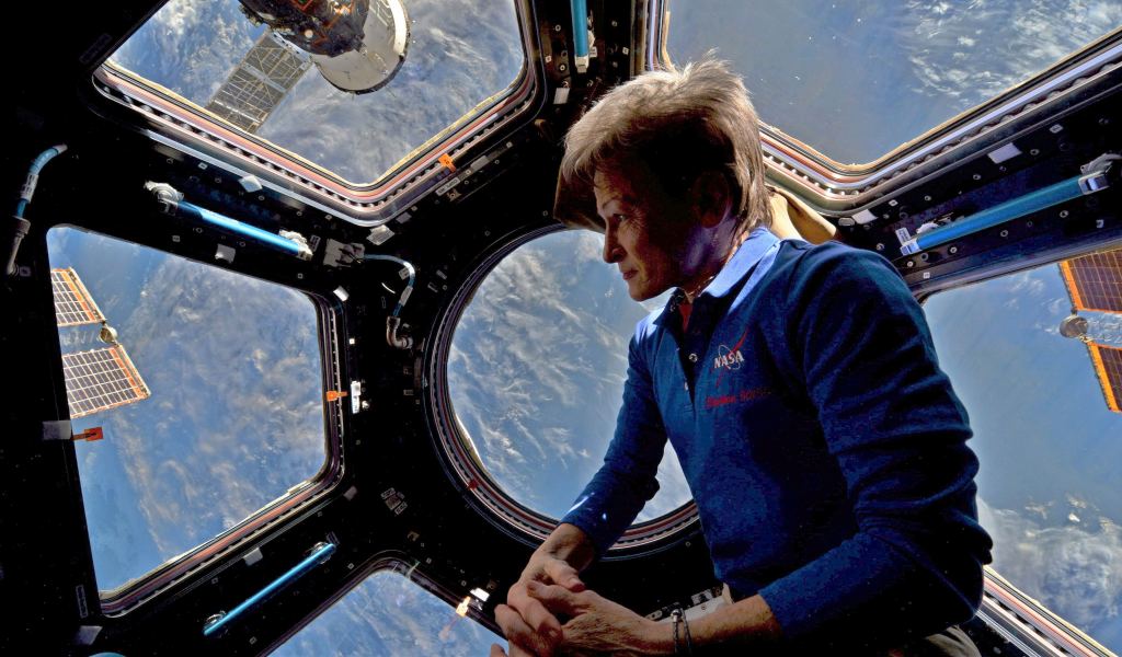 Astronaut Peggy Whitson in the International Space Station's Cupola during a 2017 tour of duty. Doctors are interested in how long periods in low gravity change an astronaut's brain. (NASA Photo)