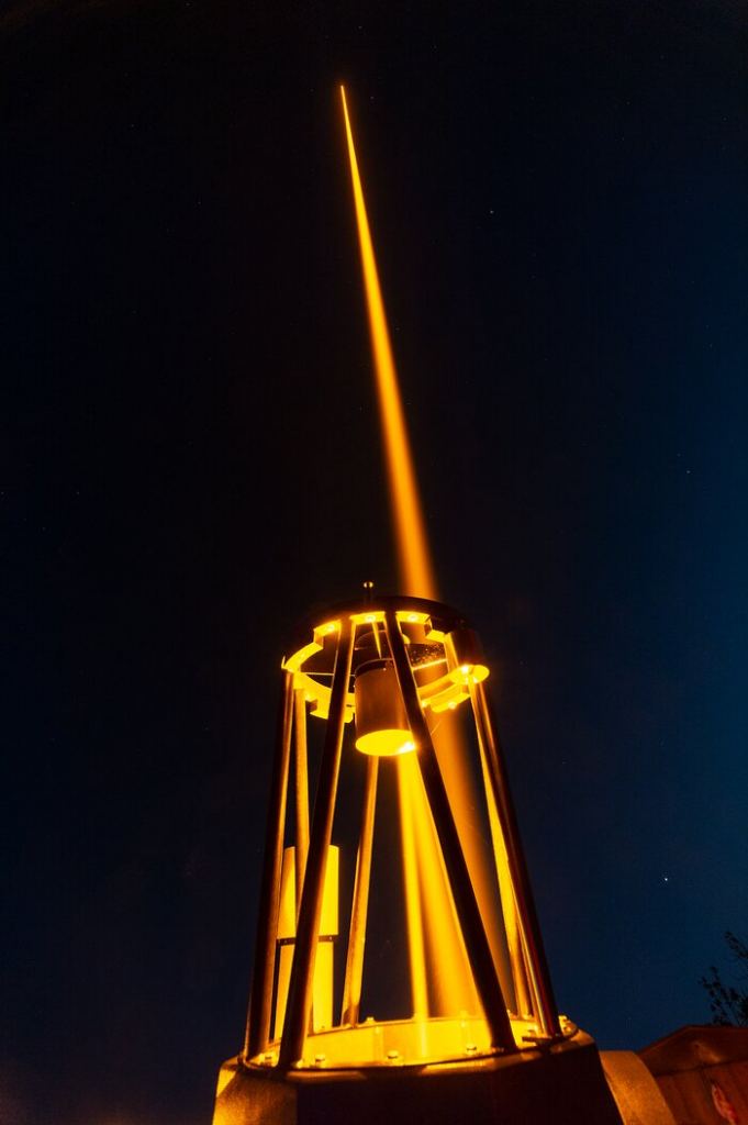 This image shows the 57W CaNaPy laser during a field test on the 0.6m telescope at the Allgäuer VolksSternwarte Ottobeuren observatory in Germany. The laser light goes from the interior of the telescope to its secondary mirror and bounces back to the primary mirror, where it is finally reflected towards the sky.  The laser, based on ESO patented technology, will eventually form part of the CaNaPy Laser Guide Star Adaptive Optics system to operate at the European Space Agency’s Optical Ground Station in Tenerife, Spain. It will help correct astronomical observations for the blurring effect caused by turbulence in the Earth’s atmosphere.
