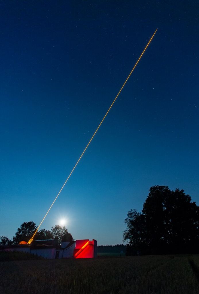 This wide-field image shows the CaNaPy laser being tested on-sky at the Allgäuer VolksSternwarte Ottobeuren observatory in Germany. The laser, based on ESO-patented technology, excites sodium atoms in the upper atmosphere, creating an artificial source that can be used to monitor and correct atmospheric turbulence. This laser will be eventually installed at the European Space Agency’s (ESA) Optical Ground Station in Tenerife, Spain, as part of a collaboration between ESO and ESA to use adaptive optics for astronomical and satellite communication purposes.