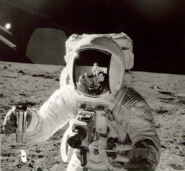 In this image, an Apollo 12 astronaut holds a core sample inside a container. Image Credit: NASA