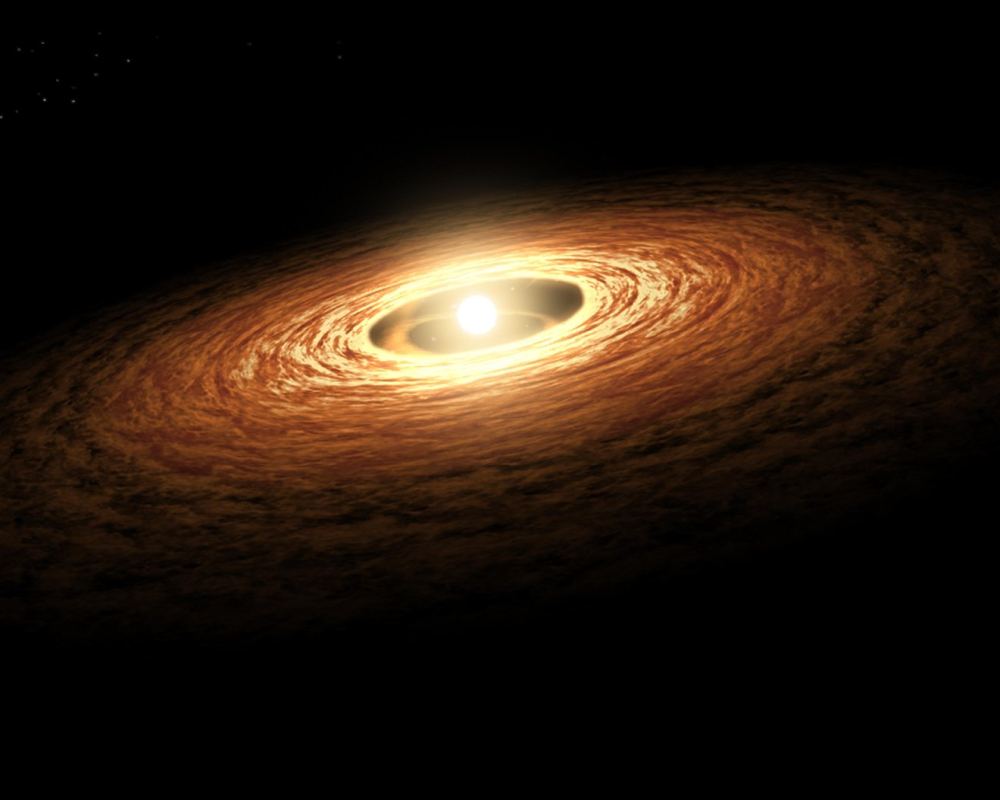 This artist's concept shows a protoplanetary disk around a young star. If this new research is accurate, then rocky planets can form quickly with water as part of the process. There's no requirement for water-rich impactors to deliver it after the planet has already formed. Credit: NASA/JPL-Caltech 