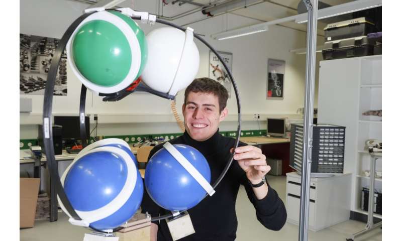 Froissart with his exoskeleton device that will launch ball shaped robots into lunar lava caves.
