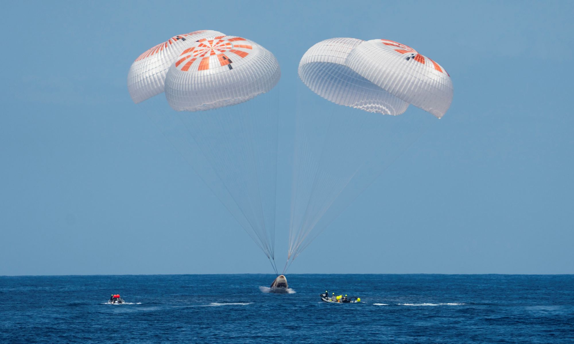 Dragon splashdown with parachutes