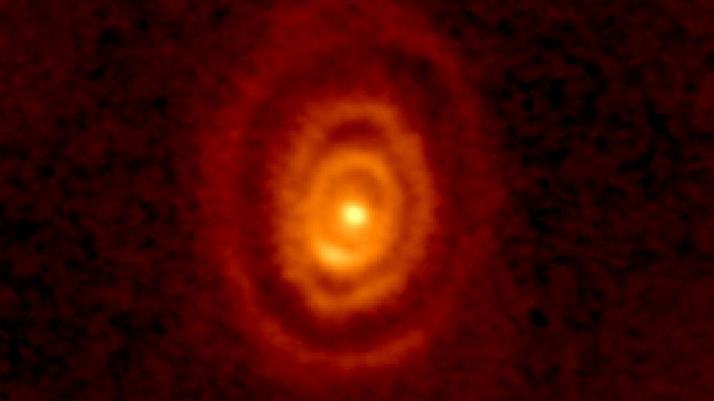 Three rings of ejected gas sail away from an aging star named V Hydrae, seen in this false-colour radio image from the Atacama Large Millimeter/submillimeter Array in Chile. Image Credit: ALMA