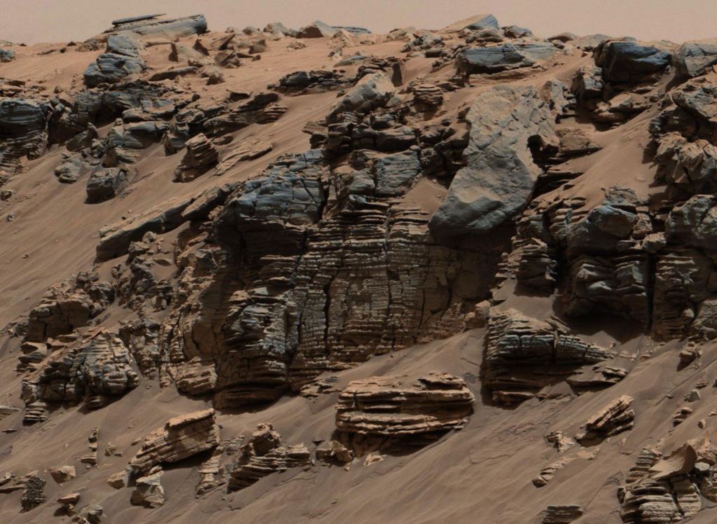 Another mast cam view of eroded sedimentary rock (may have been deposited long ago on the lake floor of the Gale Crater). This scene is not far from where the water flowed into the lake. Credit: NASA / JPL-Caltech / MSSS