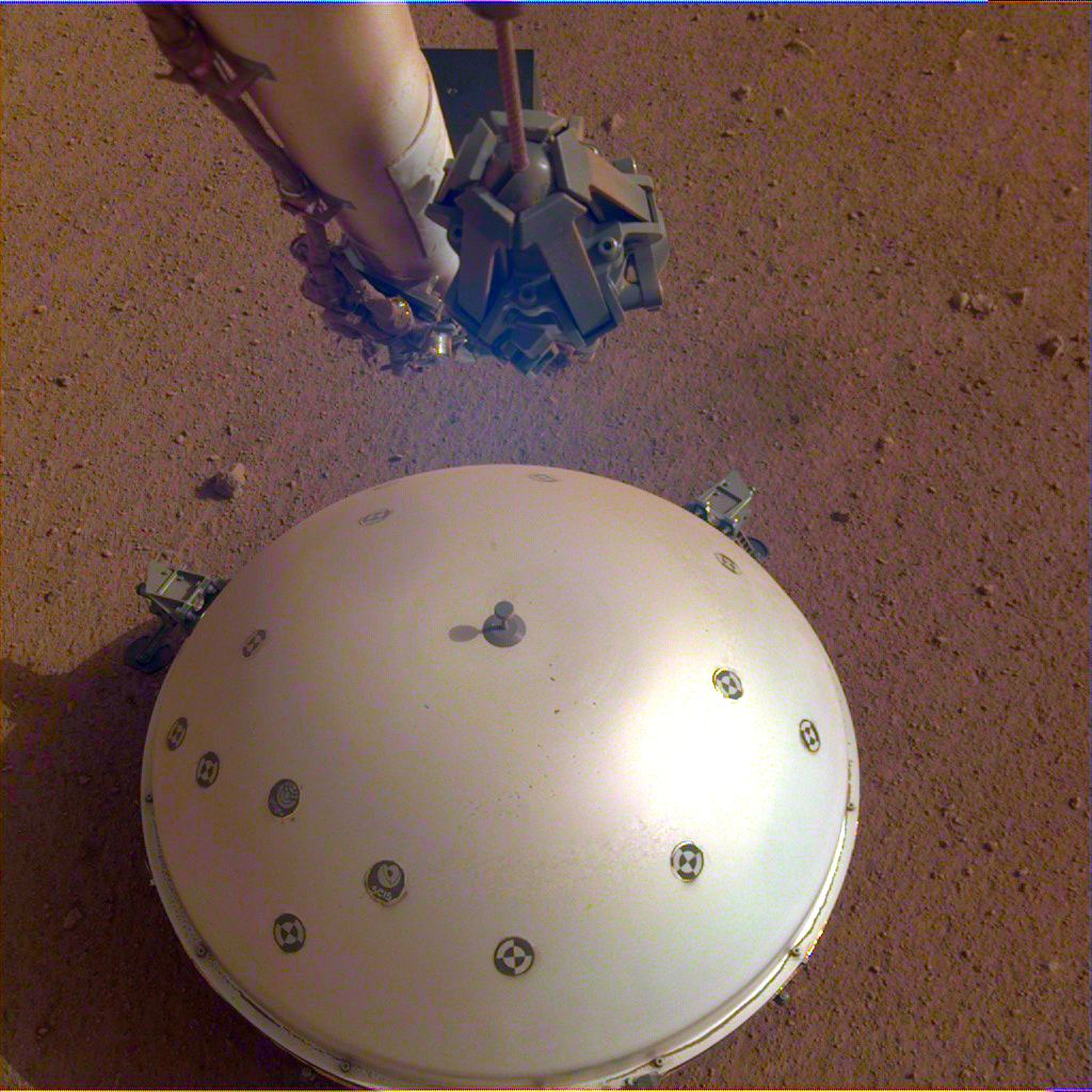 The dome wind and the InSight heat shield that covers its seismometer is called the Seismic Experiment for Interior Structure, or SEIS.  Credit: NASA / JPL-Caltech