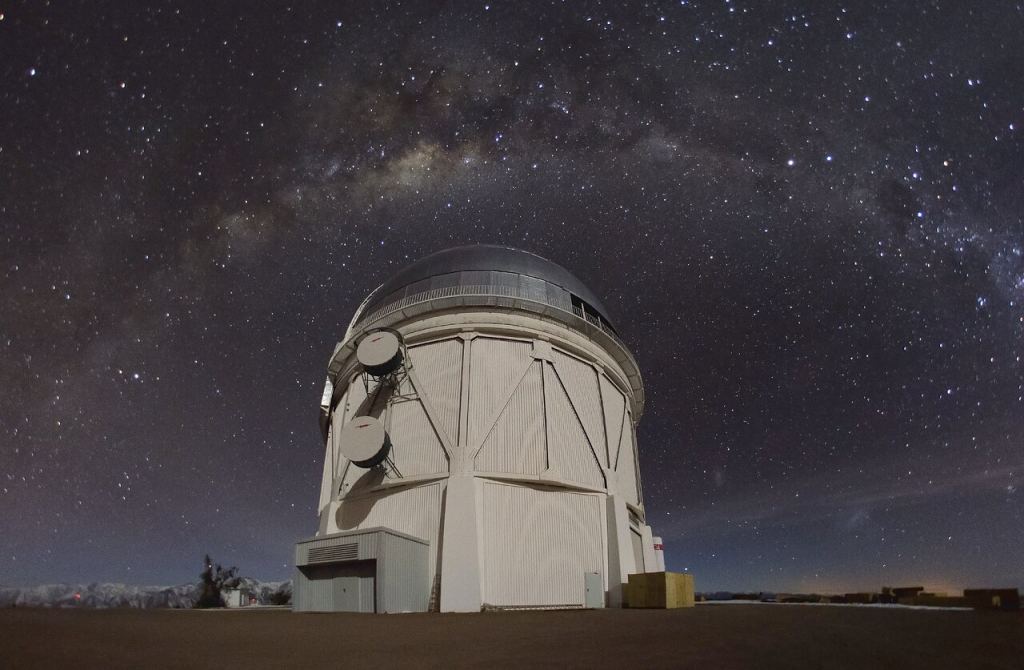 The 4-meter dome of the Victor M. Blanc Telescope appears under the Milky Way at the Serra Talola Inter-American Observatory.  Provided by NOIRLAb.