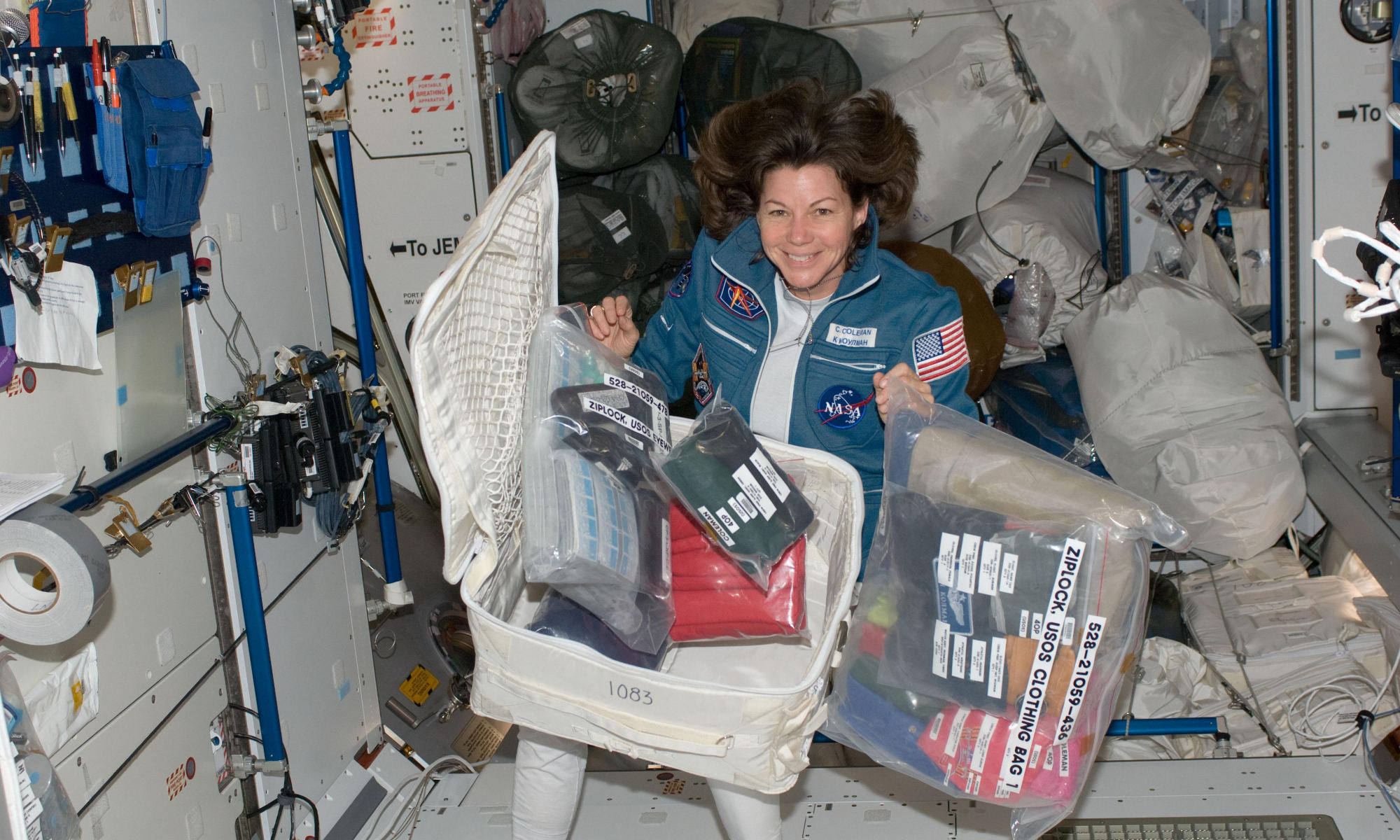 ISS026-E-011334 (18 Dec. 2010) --- NASA astronaut Catherine (Cady) Coleman, Expedition 26 flight engineer, is pictured with a stowage container and its contents in the Harmony node of the International Space Station.