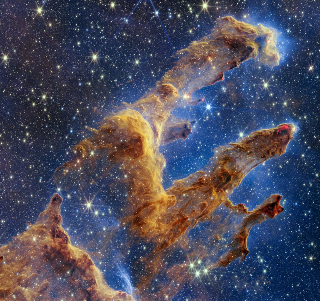 創造の柱は、NASA/ESA/CSA ジェイムズ ウェッブ宇宙望遠鏡の近赤外線ビューで色の万華鏡のように設定されています。 柱は砂漠の風景からそびえ立つアーチや尖塔のように見えますが、半透明のガスと塵で満たされ、絶えず変化しています。 これは、若い星が形成されている領域です。 画像著作権: NASA/ESA/CSA