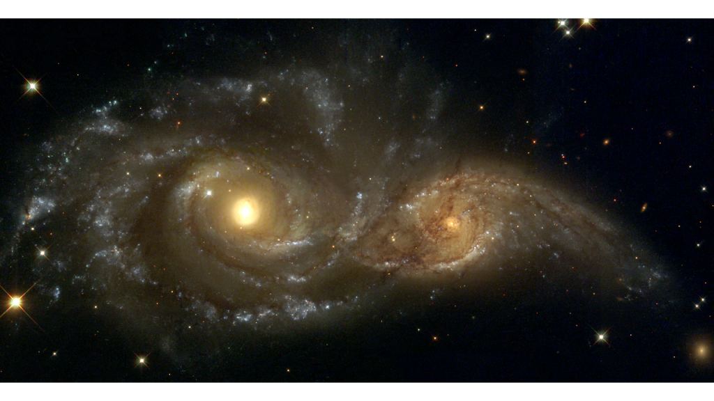 This Hubble Space Telescope images show what tidal stripping looks like. The larger galaxy on the left is NGC 2207 and the less massive one on the right is IC 2163. NGC 2207's stronger tidal forces are stripping stars from IC 2163. The stripped stars are ejected into long streamers towards the right side of the image. The streamers are a hundred thousand light-years long. Image Credit: NASA and The Hubble Heritage Team (STScI). 