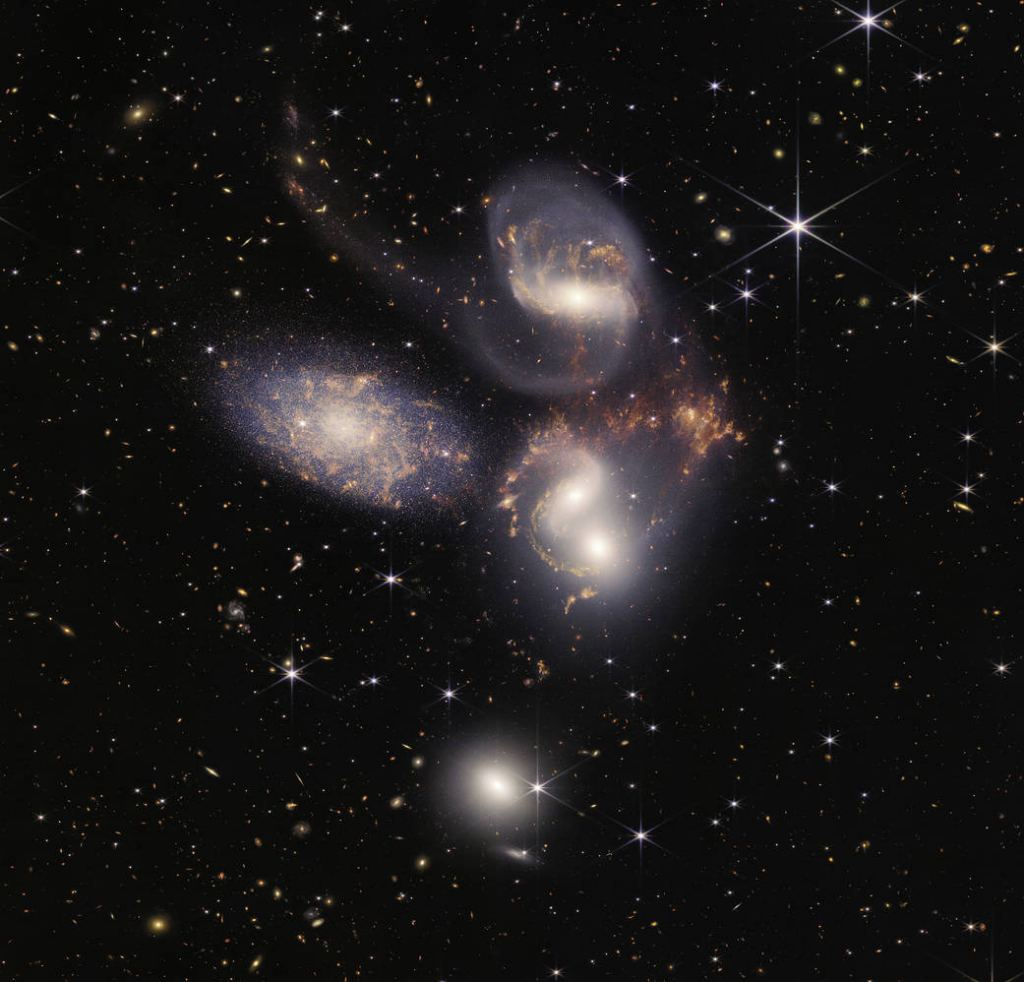 The James Webb Space Telescope captured this image of Stephan's Quintet.  There are five galaxies, four of which are interactive, and the fifth is only eye contact.  NGC7320 is the left-most galaxy in the foreground of the other four.  It appears to be a collection of nearly 1,000 unique images.  The four stars and their interactions produce tails, regions of intense star formation, bright regions containing millions of stars, and shock waves from NGC 7318B, the apex of a double galaxy that close together, while bullying in the herd.  Description: NASA, ESA, CSA, and STScI